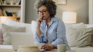 Lady thinking while using laptop